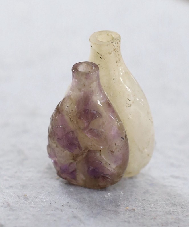 A 19th century Chinese quartz double snuff bottle, 6cm, the carver skilfully incorporating the amethyst crystal inclusions to the relief carving of the front bottle